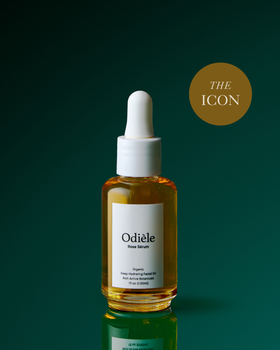 A bottle of Odièle Face Serum with a white dropper cap and a white label, filled with golden-yellow serum, set against a dark green gradient background with a gold circular badge reading 'THE ICON'.